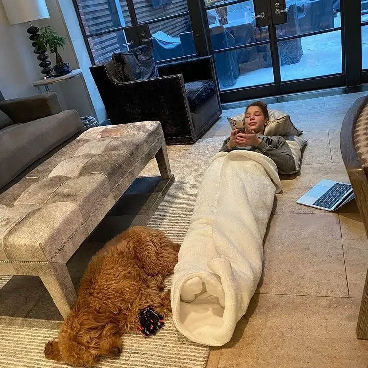 Michael Strahan's daughter lying on the living room floor