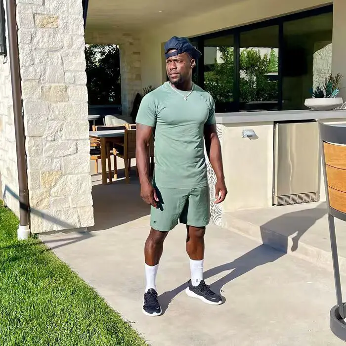 Kevin Hart standing outside his house