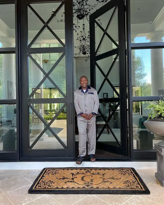 Simon Guobadia standing at his front door