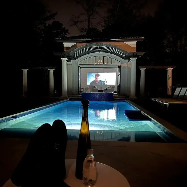Outdoor pool with a projector