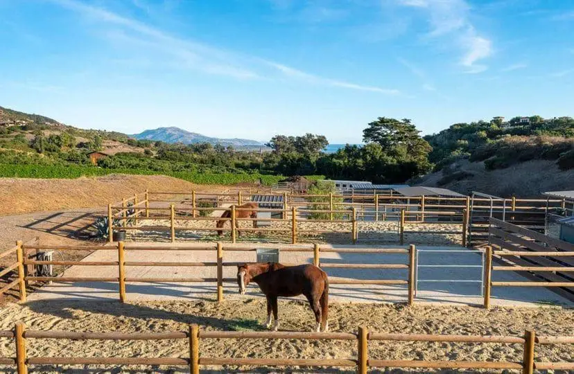 Open stables and fenced-in areas for horses at Michael Keaton’s Summerland House (Source: Mansionglobal.com)