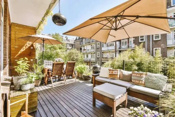 Lounge area wooden canopy in cozy balcony Lounge area with sofa and armchairs and tables under canopy in cozy balcony outdoor lounge stock pictures, royalty-free photos & images