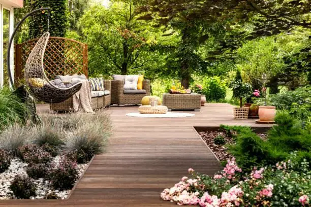 Wooden terrace surrounded by greenery Beautiful wooden terrace with garden furniture surrounded by greenery on a warm, summer day outdoor lounge stock pictures, royalty-free photos & images