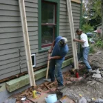 Men Doing Foundation Repair On A House