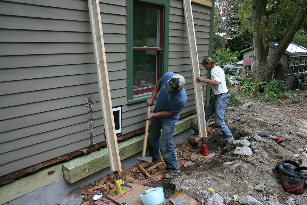 Men Doing Foundation Repair On A House